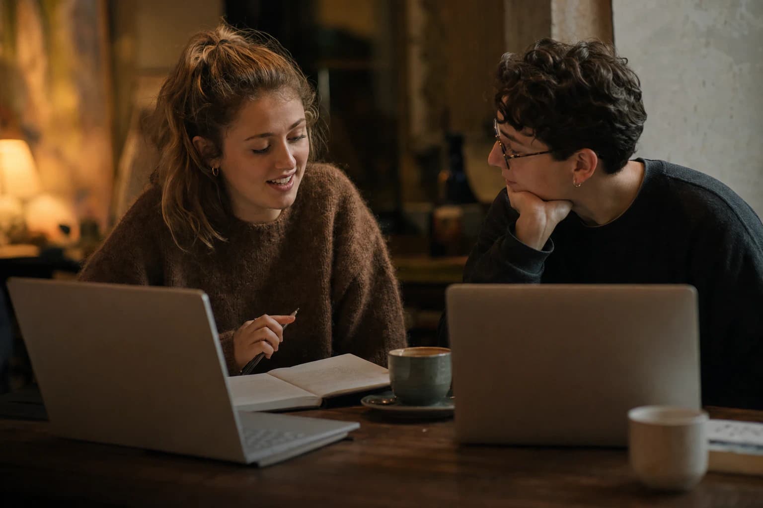 Mentor and student in a candid one-to-one discussion over notes