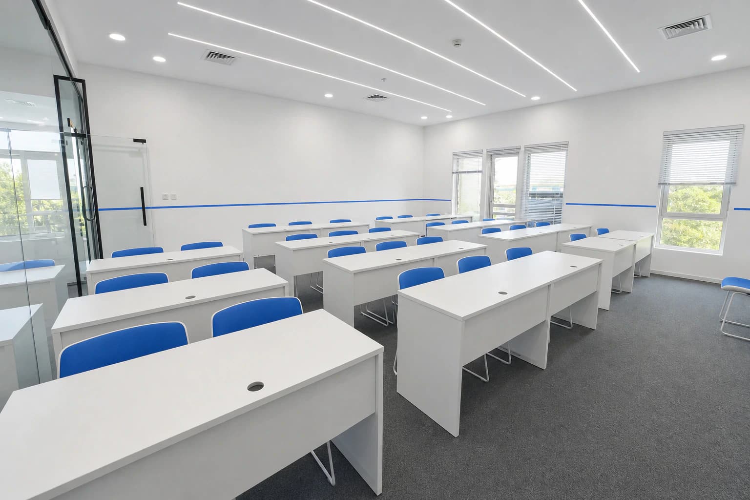 Bright classroom with rows of desks for lessons and workshops